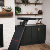 Close-up of dip bar attachment on PowerBench 2.0 in a modern home gym setting.