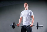 man lifting a home barbell set ez curl bar for home garage gym