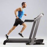 Man using an American-made treadmill for a home cardio workout, part of high-quality cardio equipment collection