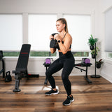 woman exercising squats with the adjustable kettlebell